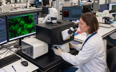 Detailed view of an automated microscope workstation in a professional imaging core facility.